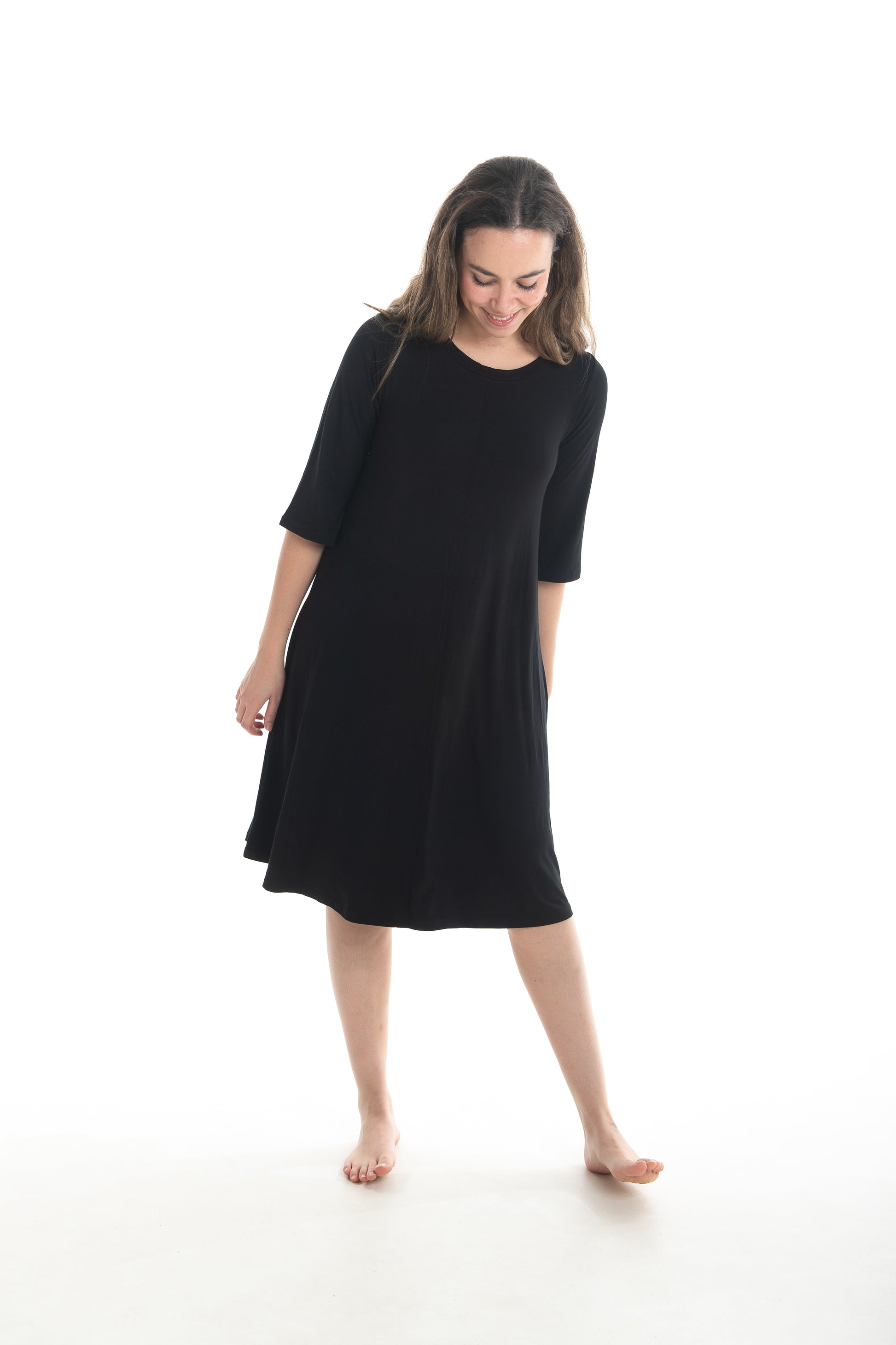 Woman wearing a black dress on a white background